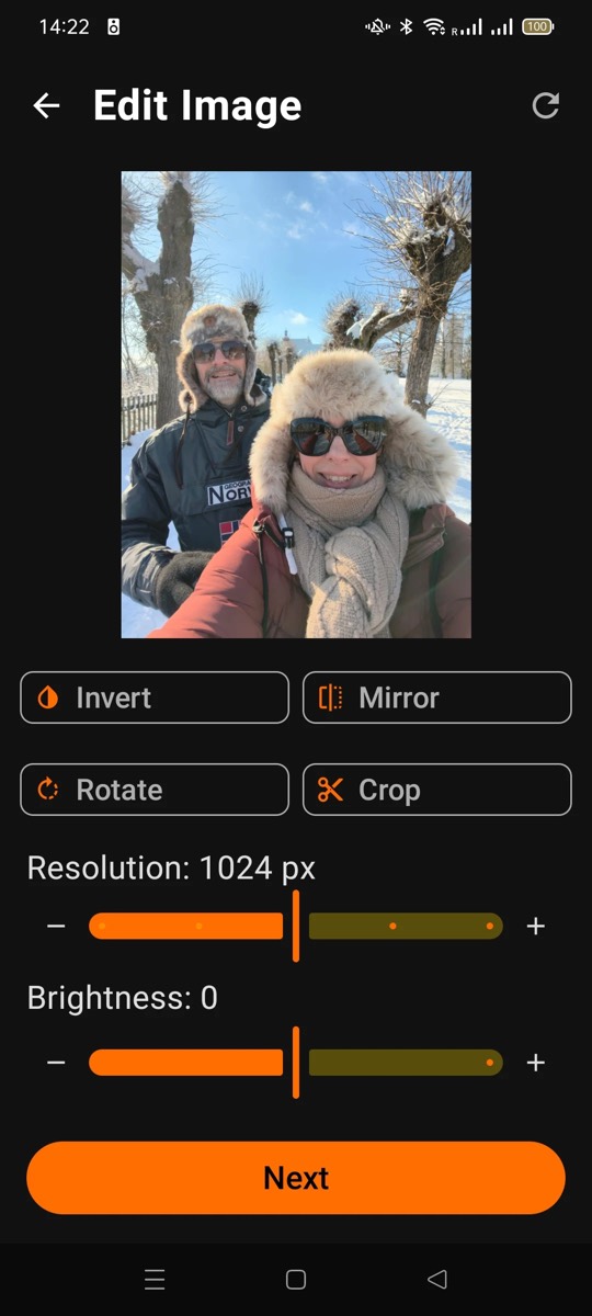 Edit Image screen with a winter photo of two people, invert, mirror, rotate and crop buttons, and resolution and brightness sliders